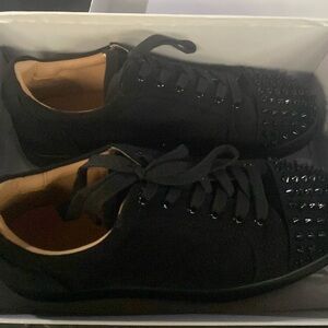 Black dress shoes with spike toed detailing.